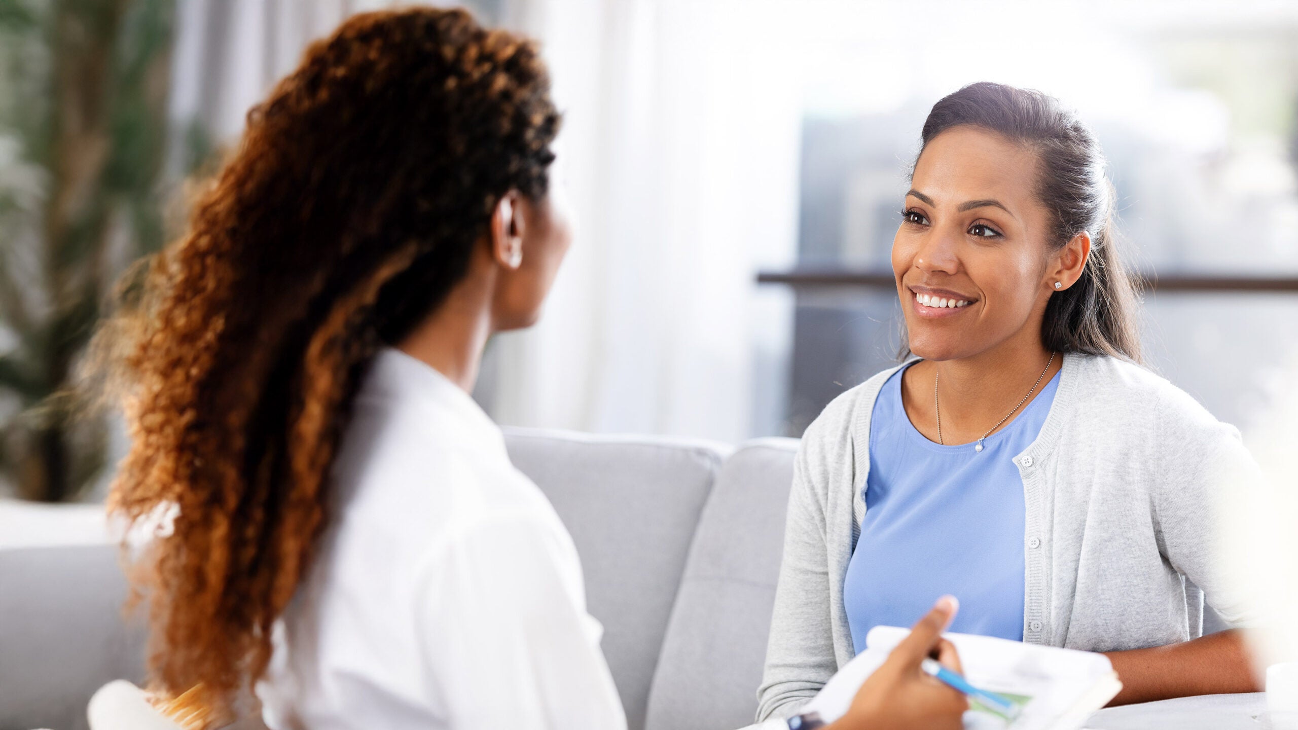 Woman doctor speaking with patient
