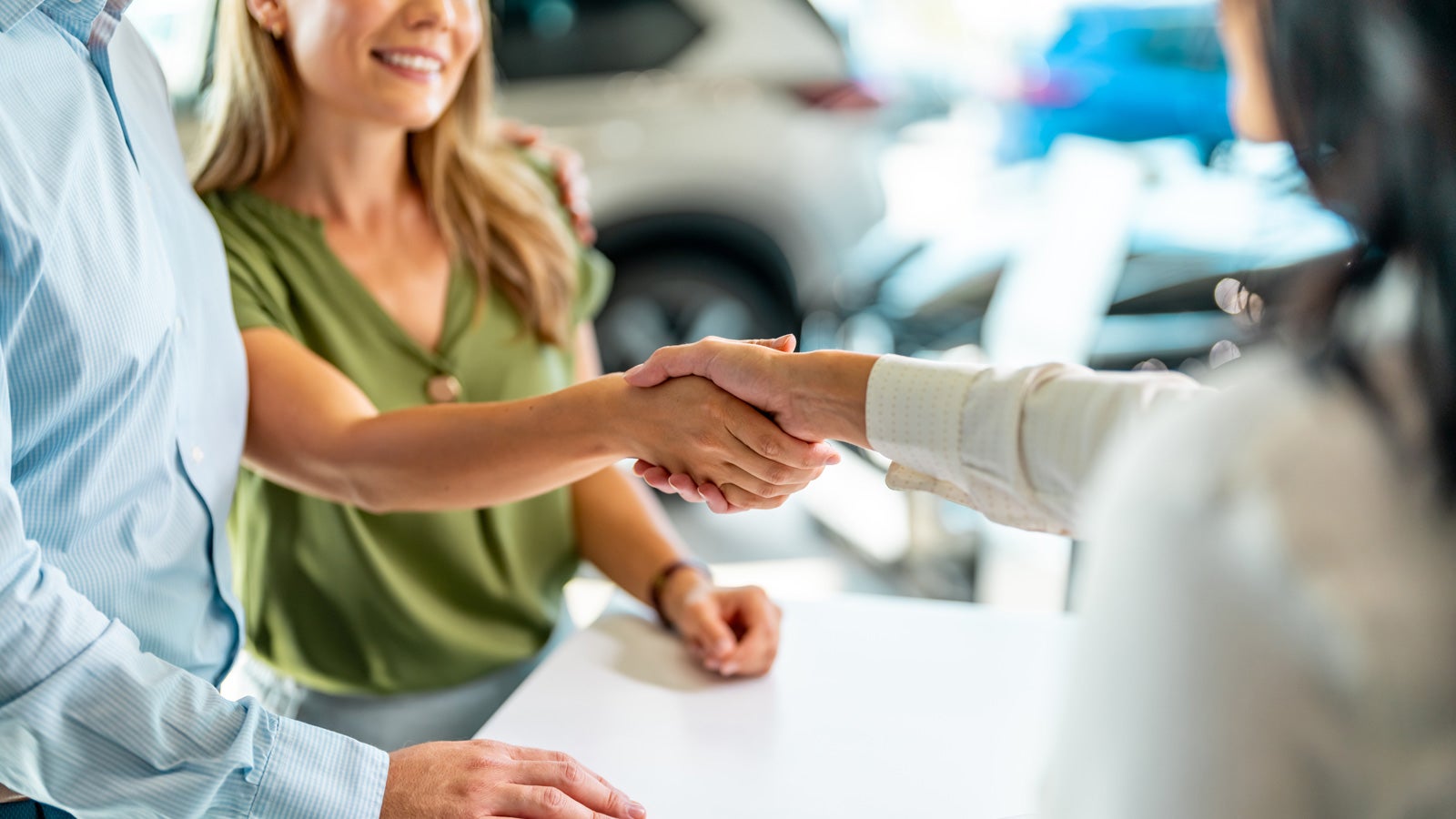 Female customer shaking hands with saleswoman