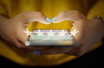 Person adding review on their phone