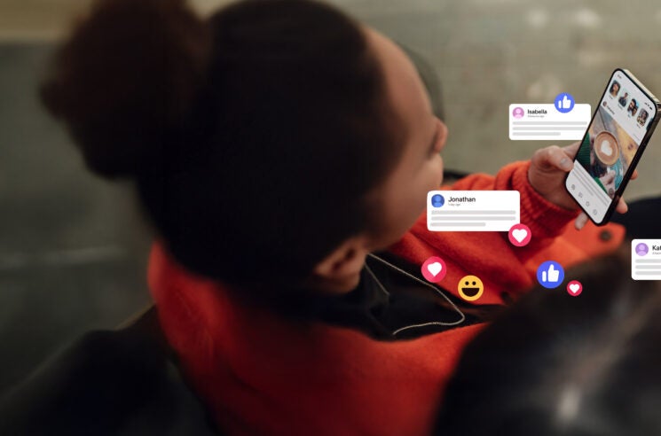 Woman holding phone with social bubble popups